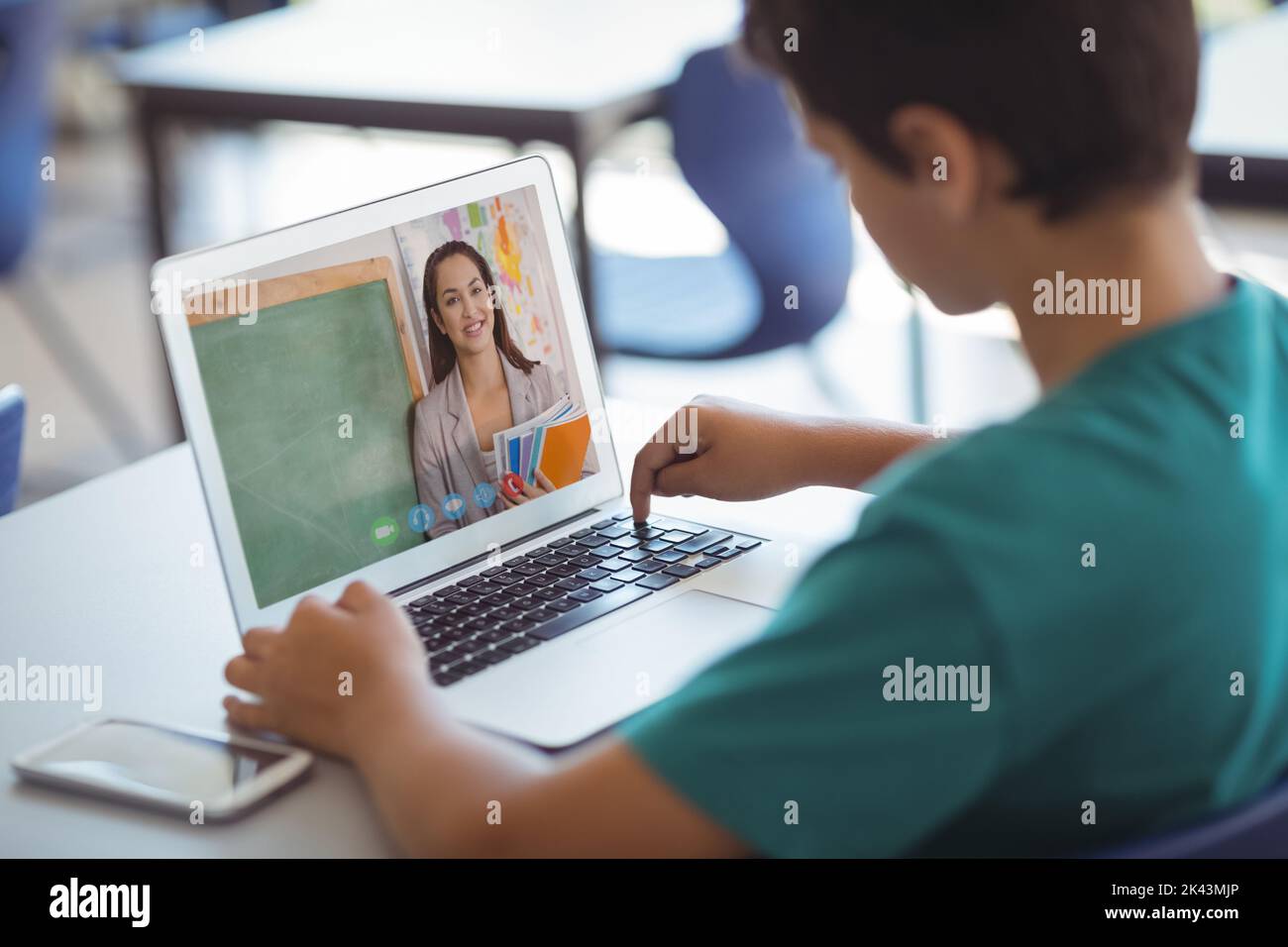 Male caucasian student having a video call with female teacher on ...