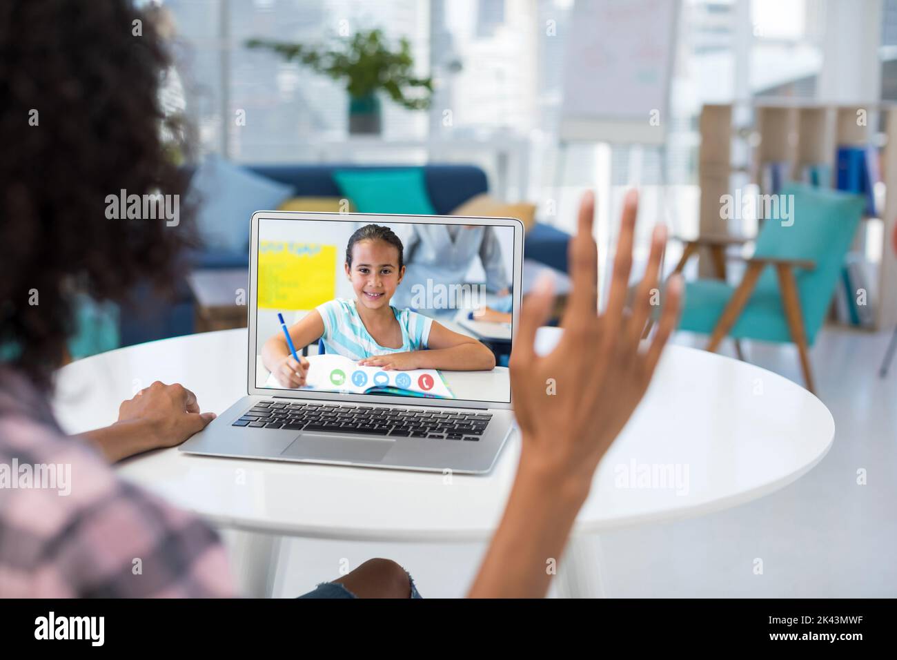 Female teacher having a video call with female student on laptop at ...