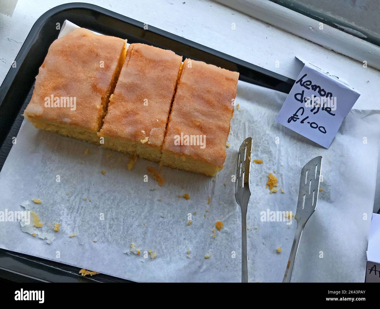 Pieces of Lemon Drizzle cake, on sale for £1 each, in a sandwich shop, Taunton, Somerset, England, UK Stock Photo