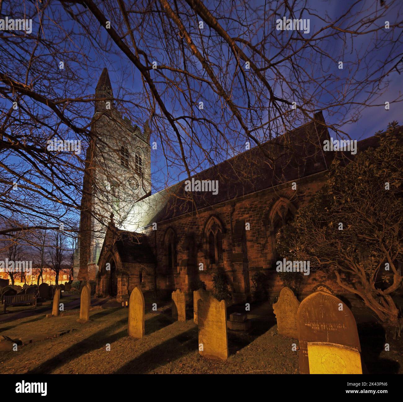 St Thomas Church and graveyard ,London Road, Stockton Heath, Warrington, Cheshire, England, UK, WA4 6HJ, at dusk Stock Photo