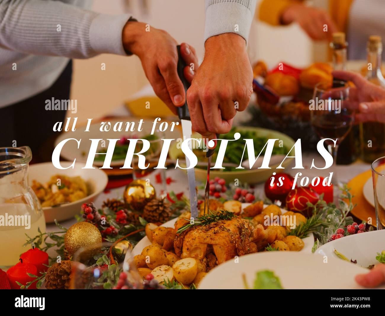 Composition of christmas text over caucasian man carving turkey on christmas table Stock Photo