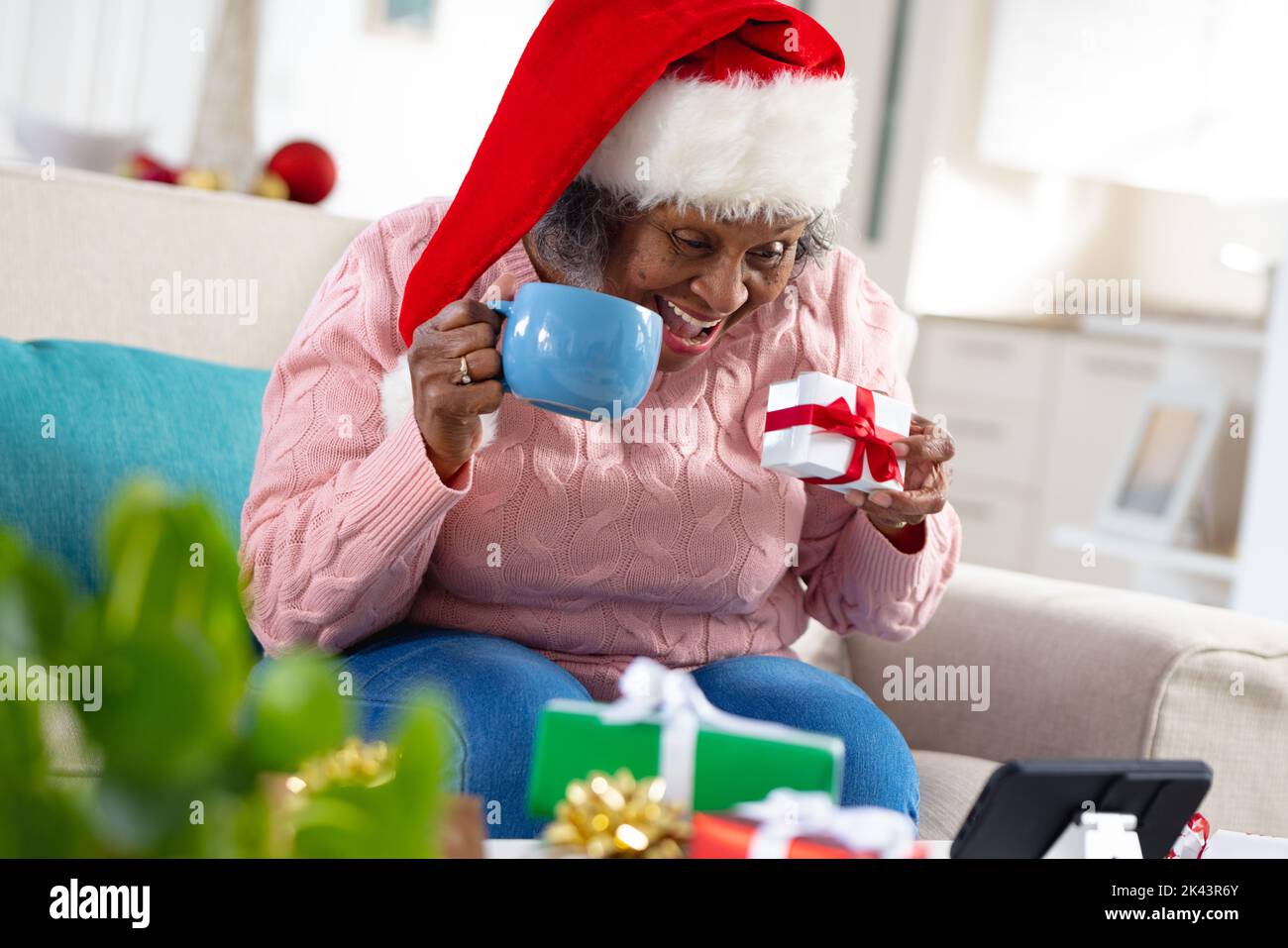 Thoughtful senior african american women wearing santa claus hat and ...