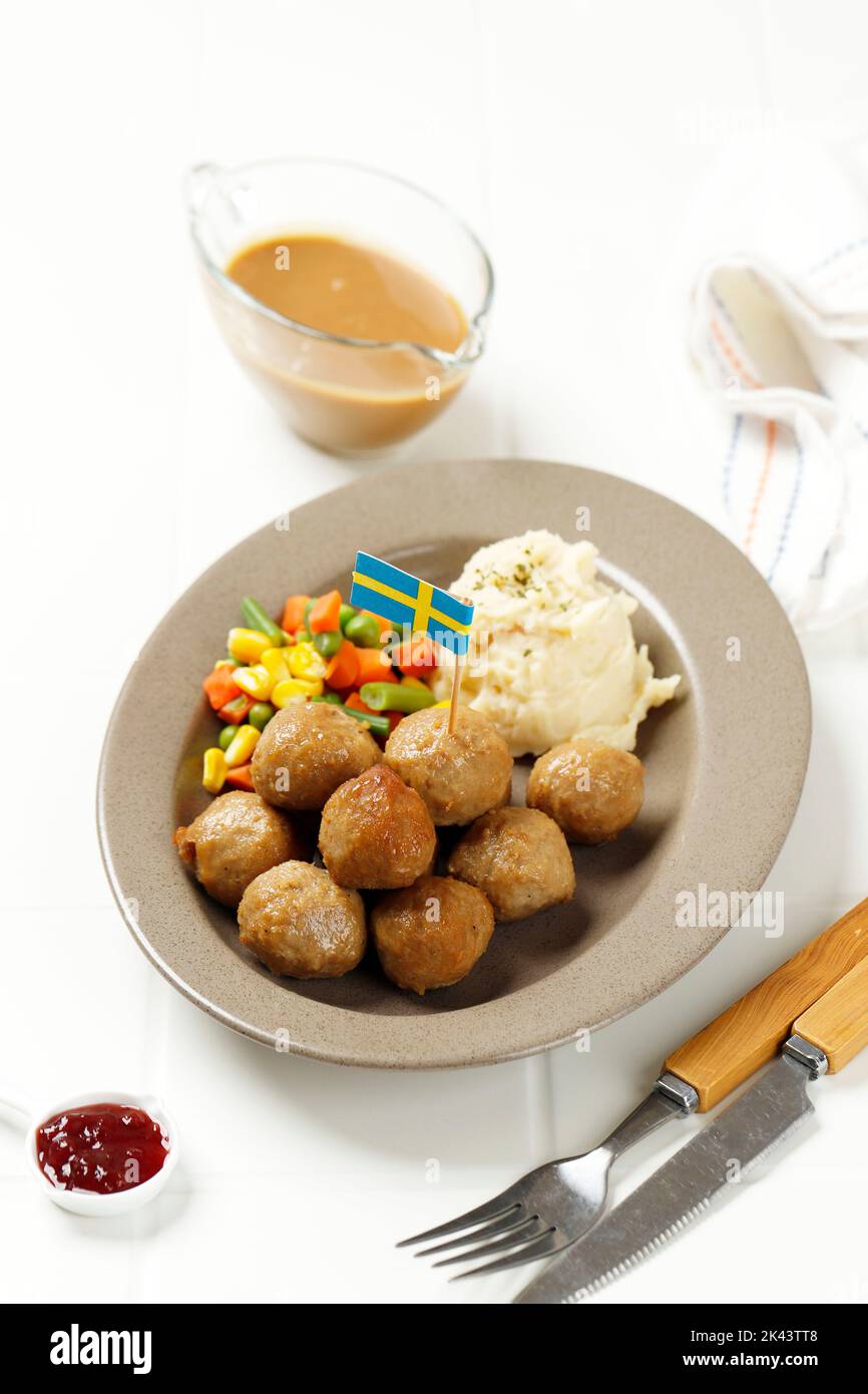 Swedish Meatballs with Mashed Potato, Mushroom Sauce, Boiled Stir Fry Vegetable, and Cranberry Sauce Stock Photo