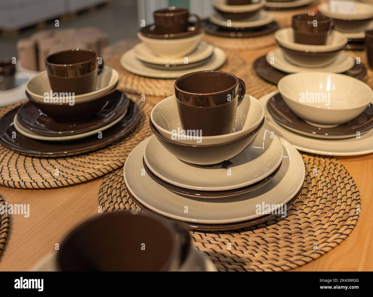 Empty plates and cups on wooden table. Ceramic tableware. Nobody, blurred, selective focus. Stock Photo