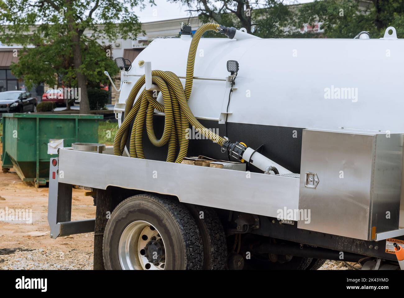 The septic truck is in the process of cleaning the portable restrooms