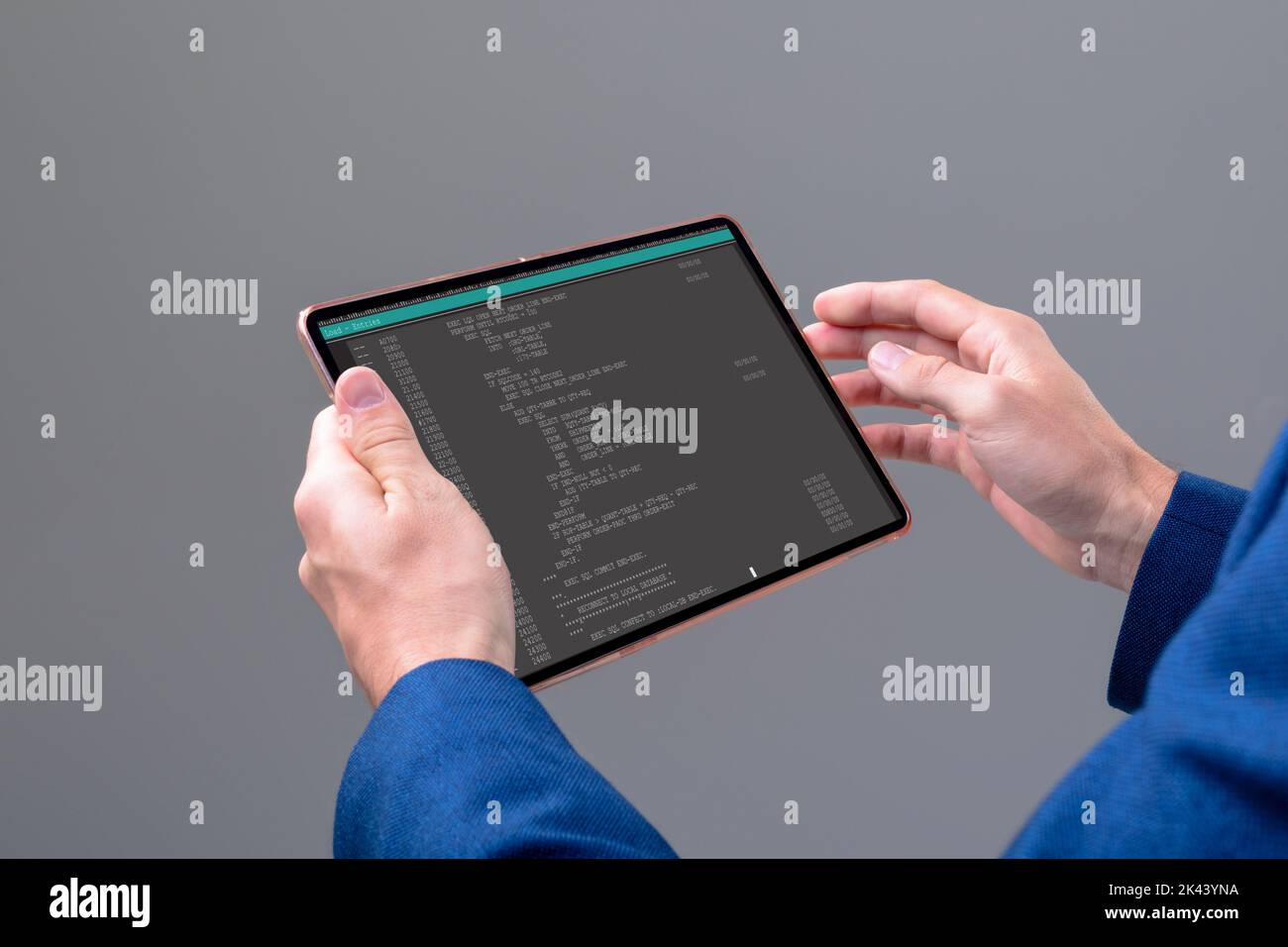 Hands of caucasian male programmer using tablet with coding on screen. coding, programming and computer technology digital composite image. Stock Photo