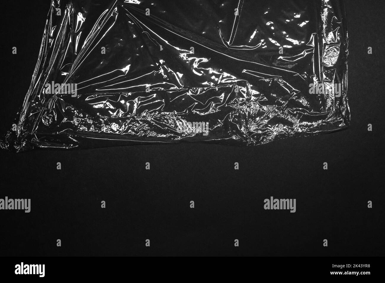 Reflecting light and shadow on creases and folds in clear plastic foil