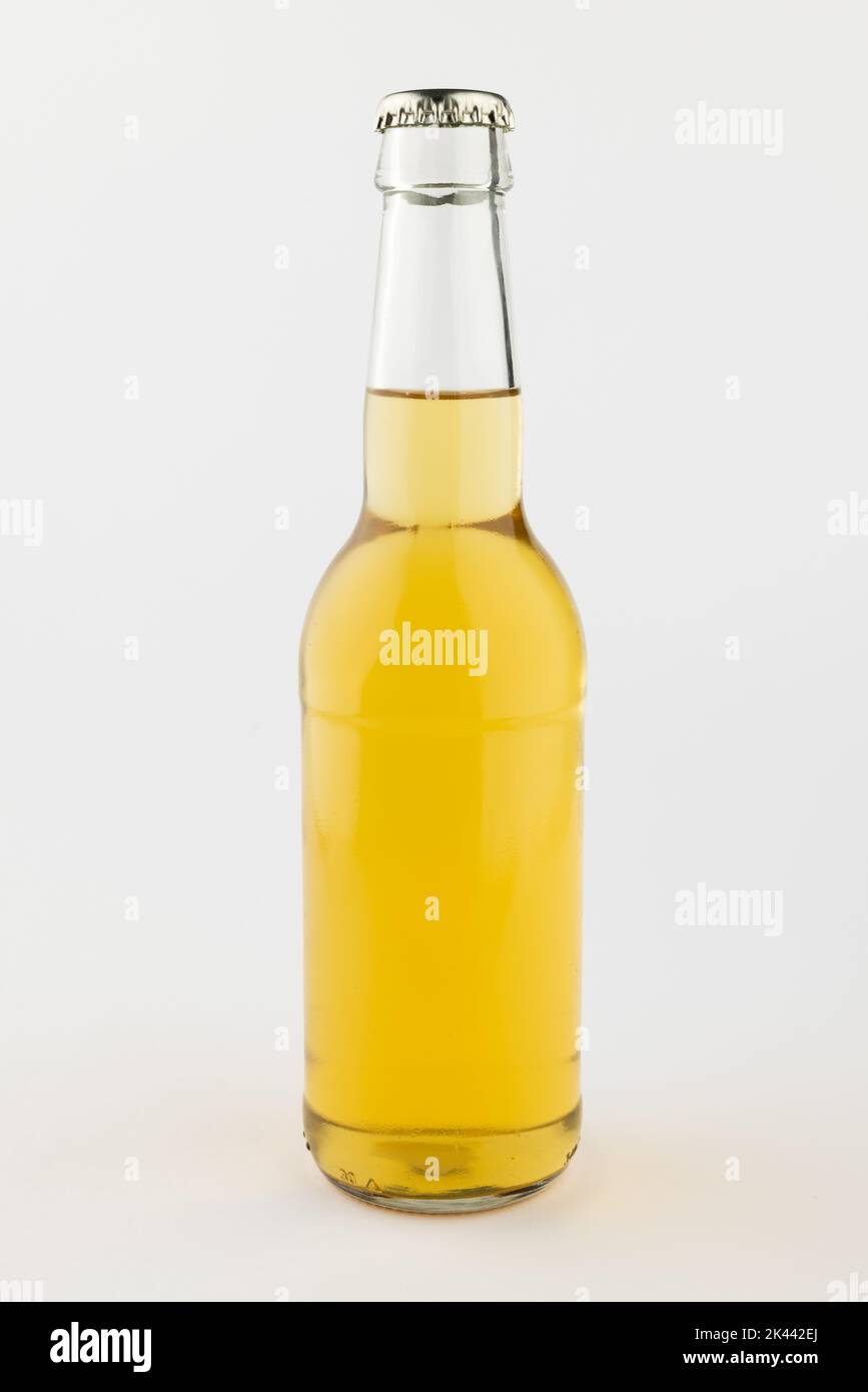 Image of clear glass full lager beer bottle with crown cap, with copy