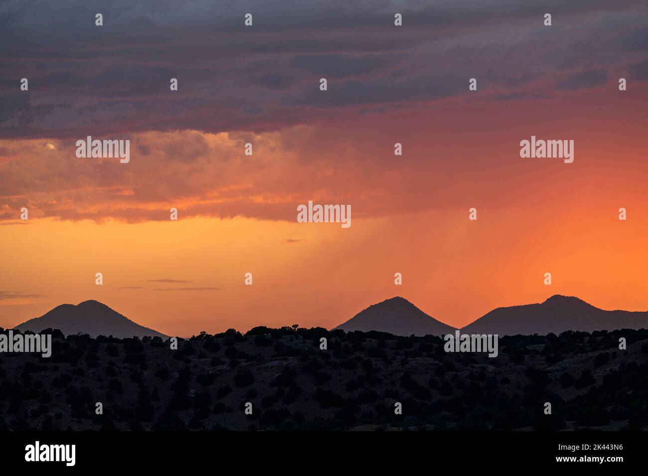 Usa, New Mexico, Lamy, Dramatic sunset sky over desert landscape Stock Photo
