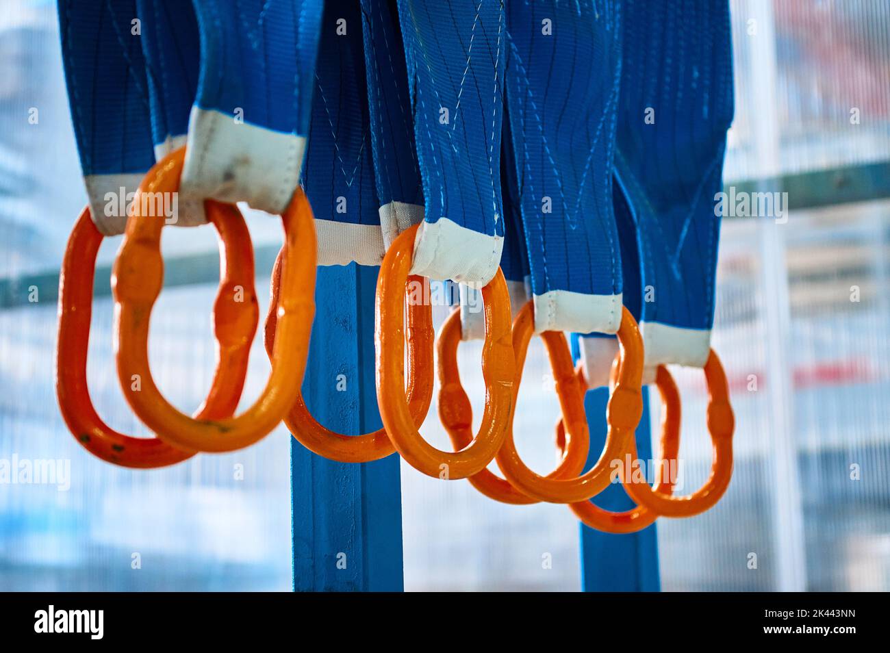 Rigging equipment with textile strops hangs on rack hooks Stock Photo