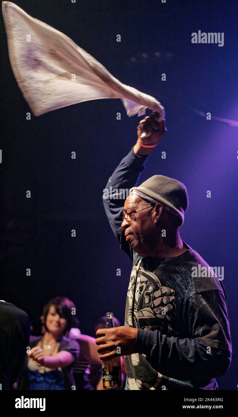 An unidentified man waves a towel in the air on stage during a Coolio concert on Monday, Oct. 5, 2009 at club 527 Main in Murfreesboro, Rutherford County, TN, USA. Born Artis Leon Ivey Jr., Coolio is perhaps best known for his mid-1990s hits 'Gangsta's Paradise' and 'Fantastic Voyage,' winning the 1996 Grammy for Best Rap Solo Performance and 1996 MTV Video Music Award for 'Gangsta's Paradise' and being crowned Favorite Rap/Hip-Hop Artist at the 1996 American Music Awards. (Apex MediaWire Photo by Billy Suratt) Stock Photo