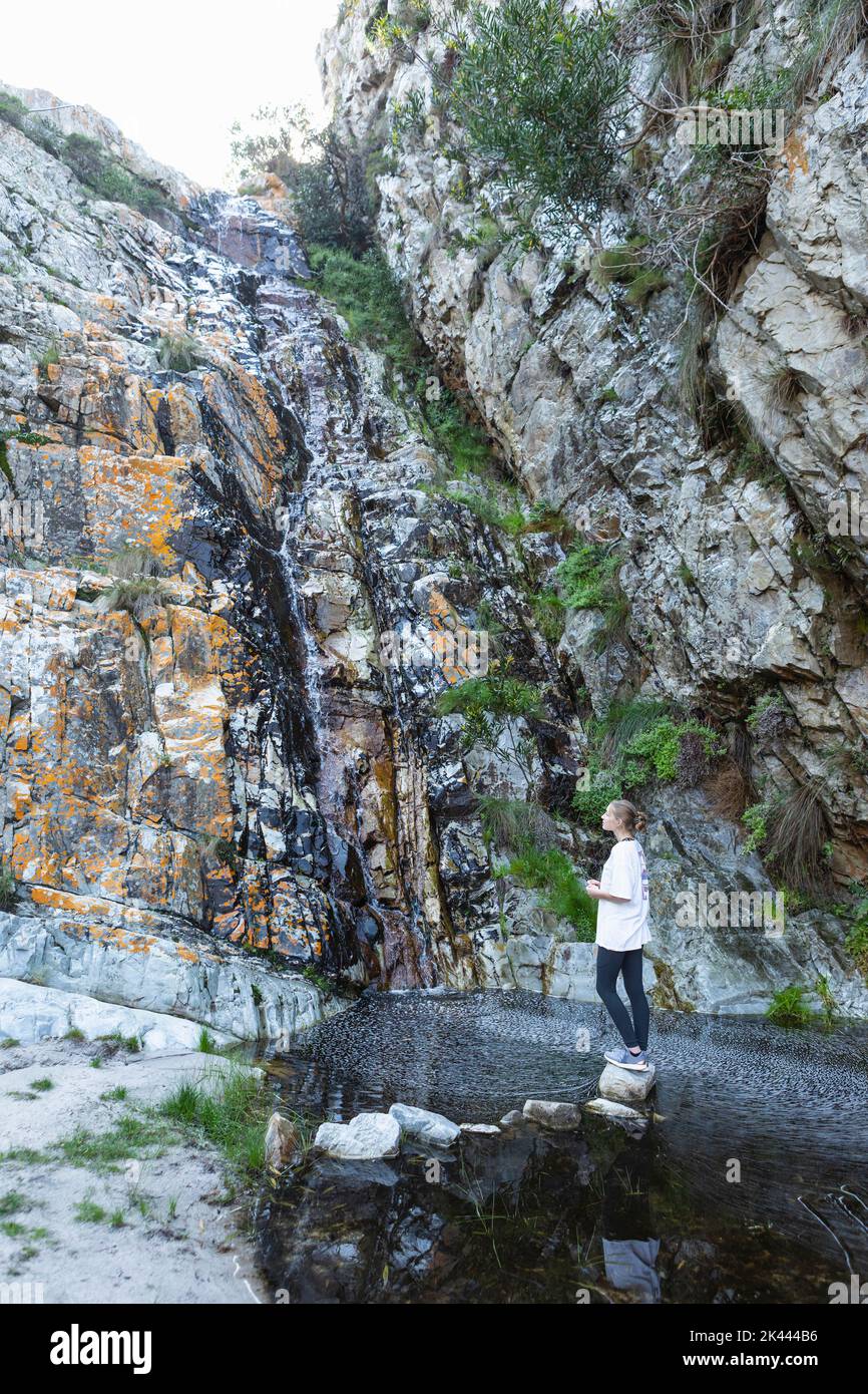 teenage girl looking at waterfall, Phillipskop Nature Reserve, Stanford, South Africa Stock Photo