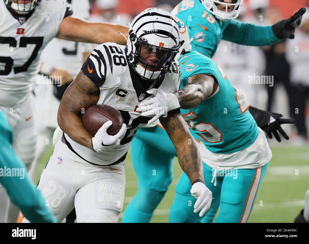 Cincinnati, United States. 29th Sep, 2022. Cincinnati Bengals halfback Joe Mixon (28) fights to break free from Miami Dolphins Xavien Ingram (25) during the first half of play at Paycor Stadium, Thursday, September 29, 2022 in Cincinnati, Ohio. Photo by John Sommers II/UPI Credit: UPI/Alamy Live News Stock Photo