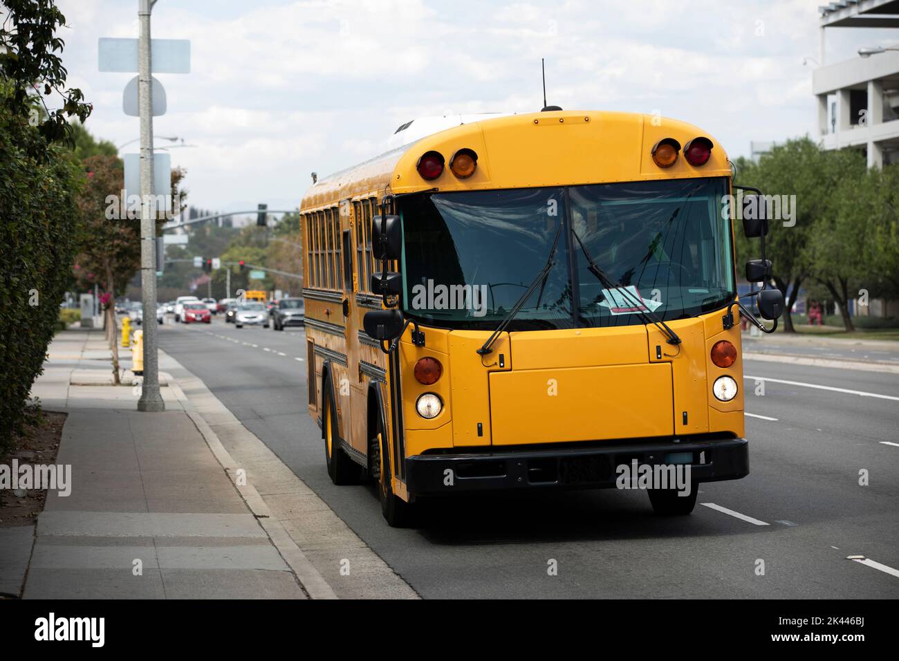 Day time view of a school bus on a city street. Stock Photo