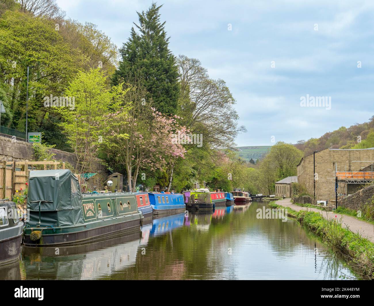 27 April 2022: Hebden Bridge, West Yorkshire, UK - Narrowboats at Mayroyd Moorings along the Rochdale Canal at Hebden Bridge. Stock Photo