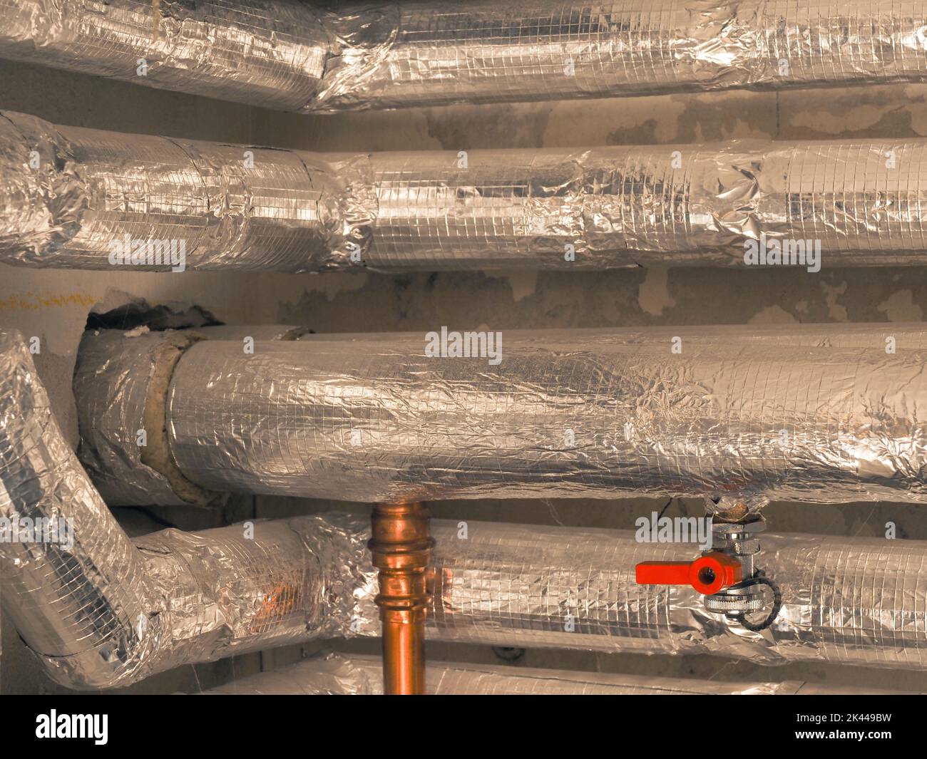 Heating pipes insulated with rock wool in a boiler room. Energy saving