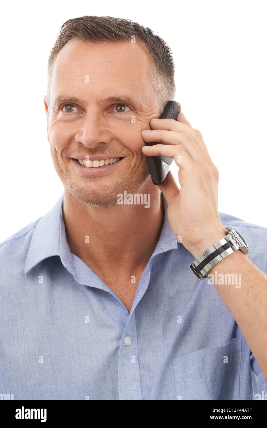 Its great to hear from you. Studio shot of a handsome man talking on a cellphone isolated on white. Stock Photo
