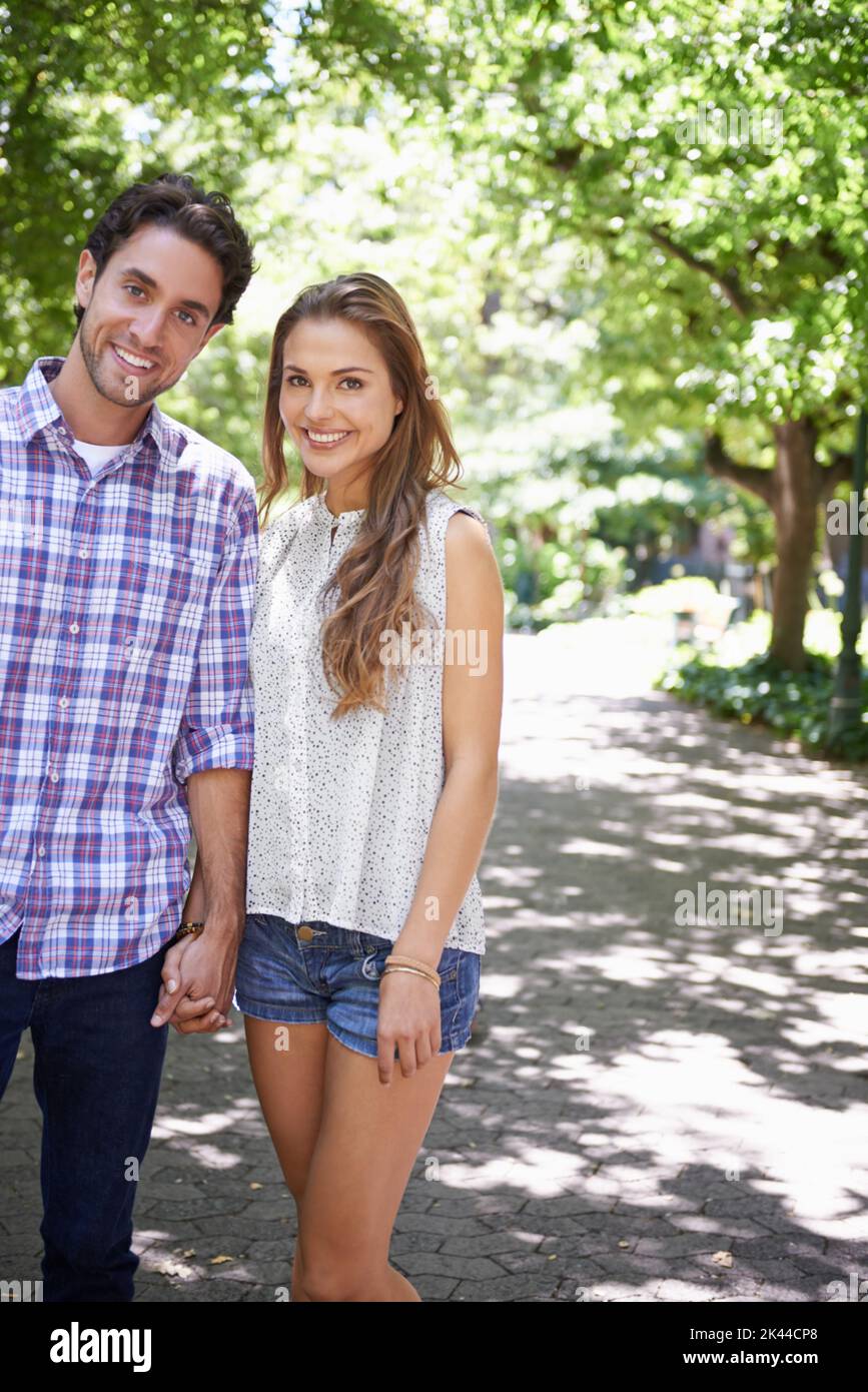 We love these quiet walks together. a happy young couple enjoying a day in a park together. Stock Photo