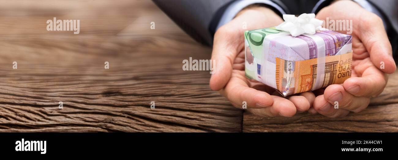 Lend Money And Hand Giving Gift Box Stock Photo