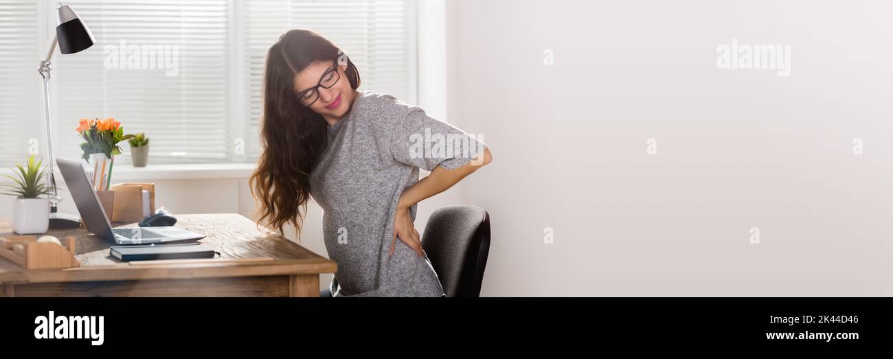 Back Pain Sitting On Chair At Work Stock Photo