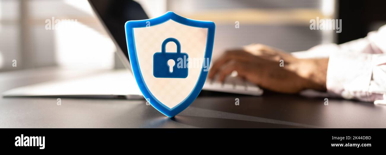 African American Man Using Secure Computer. Shield Sign Stock Photo