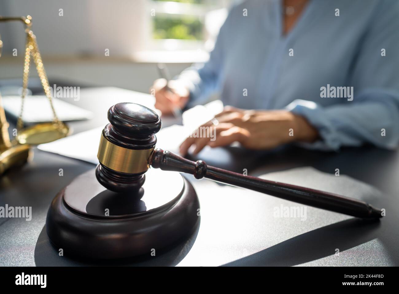 Judge With Gavel And Law Scale At Court Stock Photo