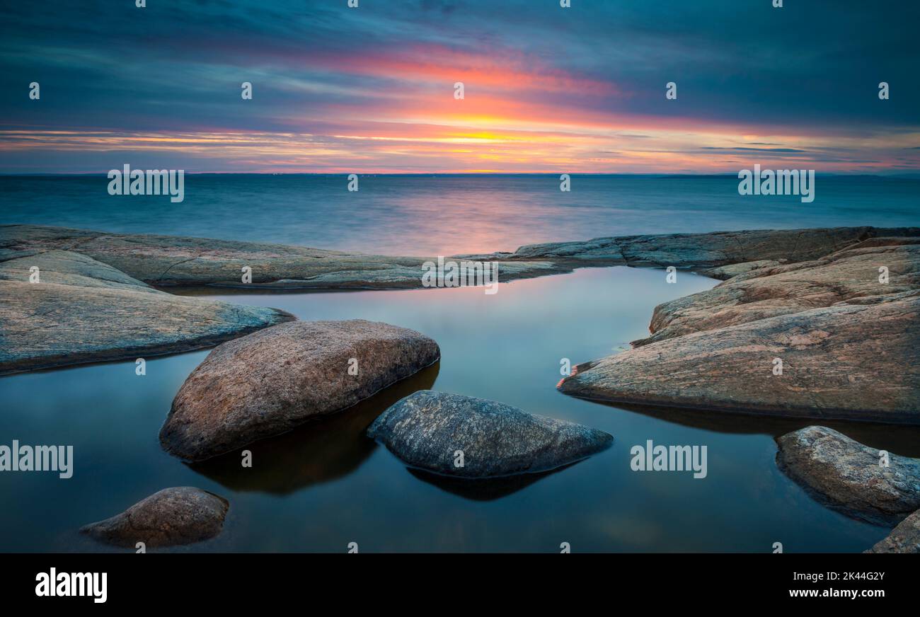 Beautiful coastal sunset and landscape with rock formations and slabs ...