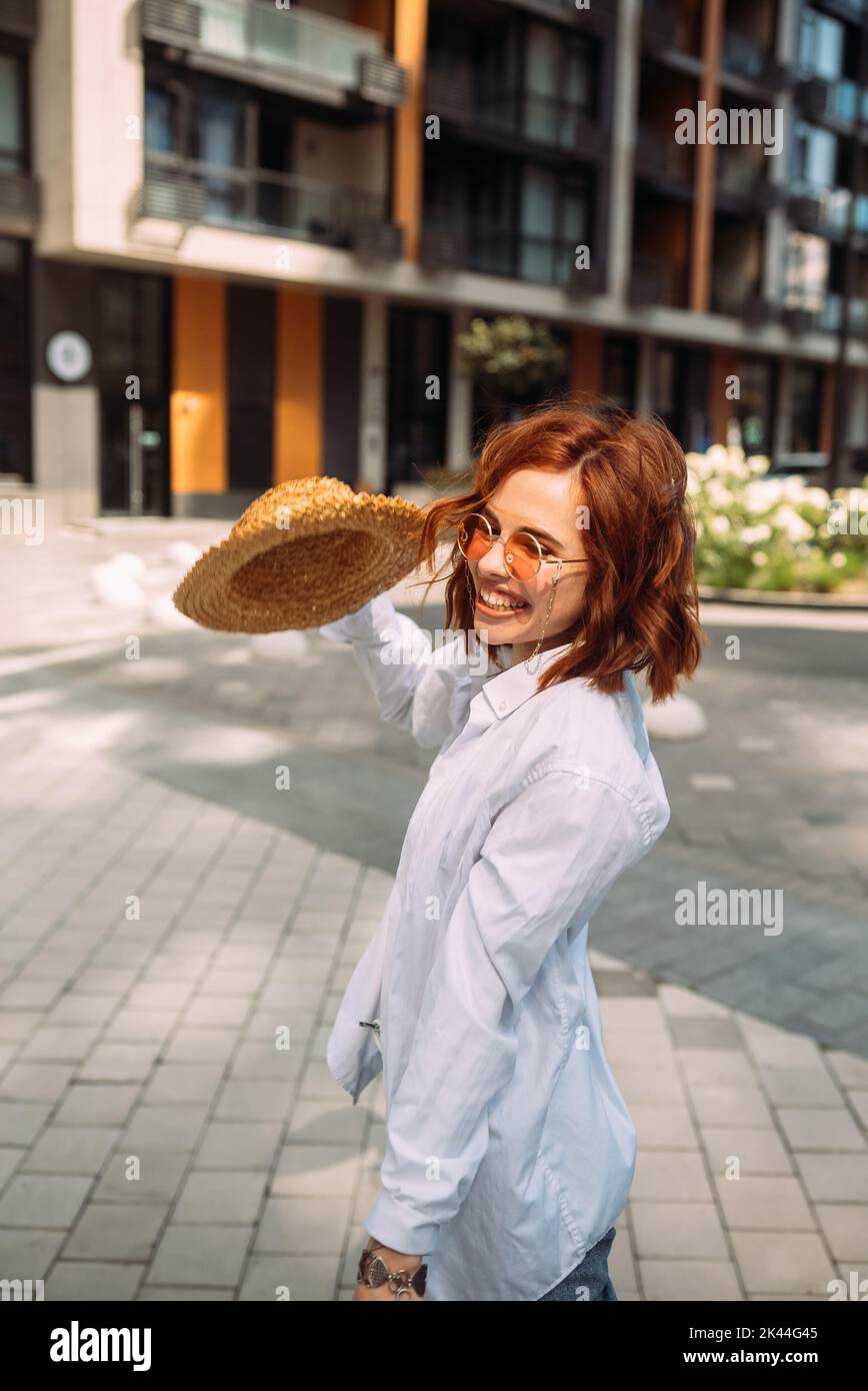 A red-haired woman poses for the camera Stock Photo