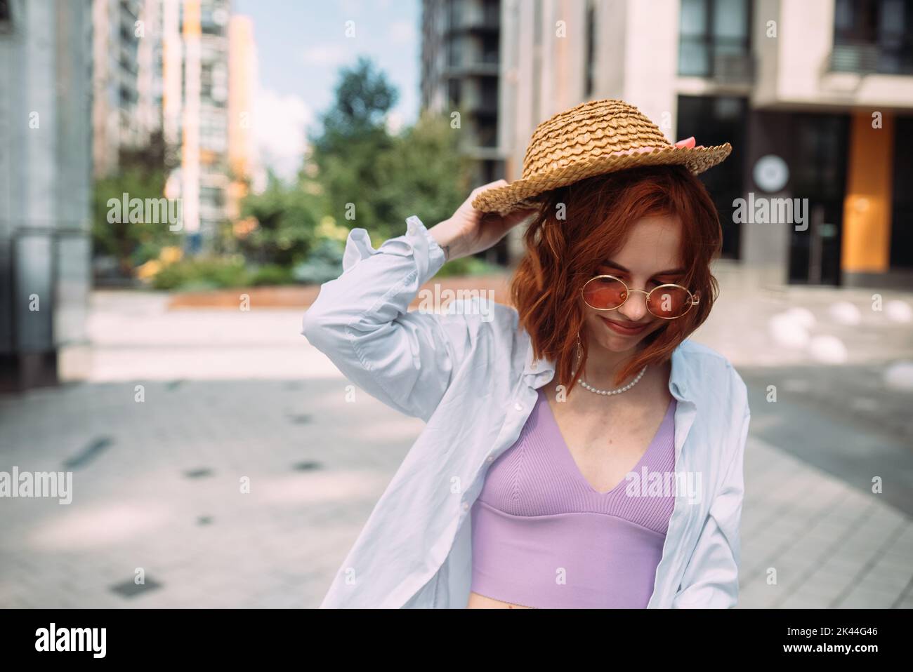 A red-haired woman poses for the camera Stock Photo