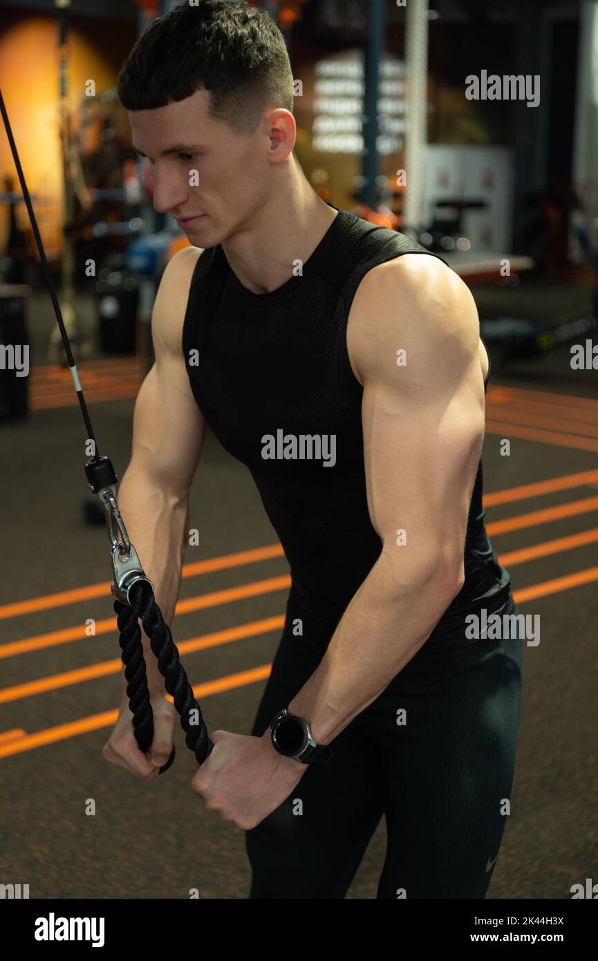 sport muscular man do weightlifting in fitness gym. weightlifting practicing muscular man in gym. Stock Photo