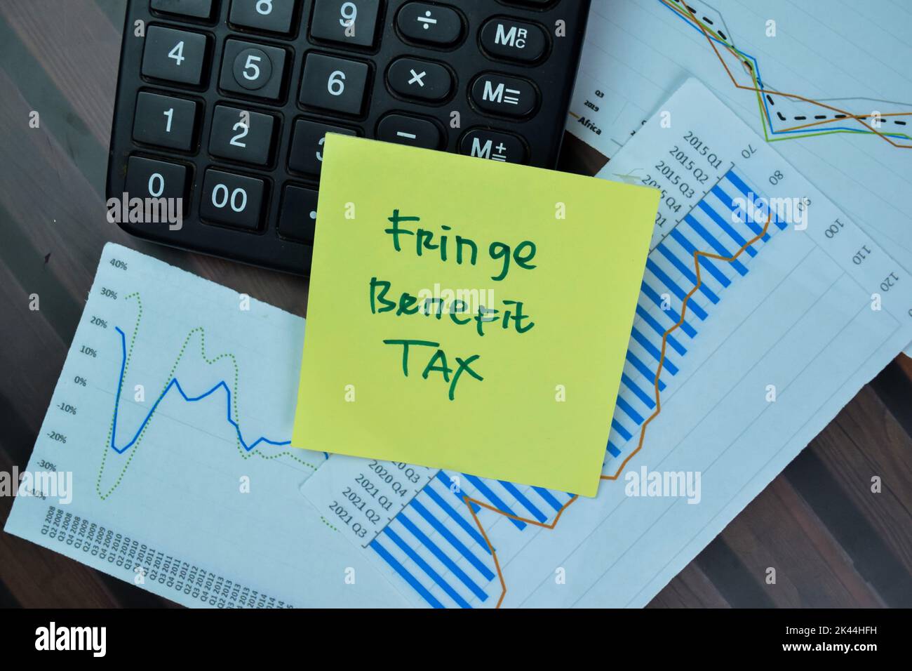 Concept of Fringe Benefit Tax write on sticky notes isolated on Wooden Table. Stock Photo