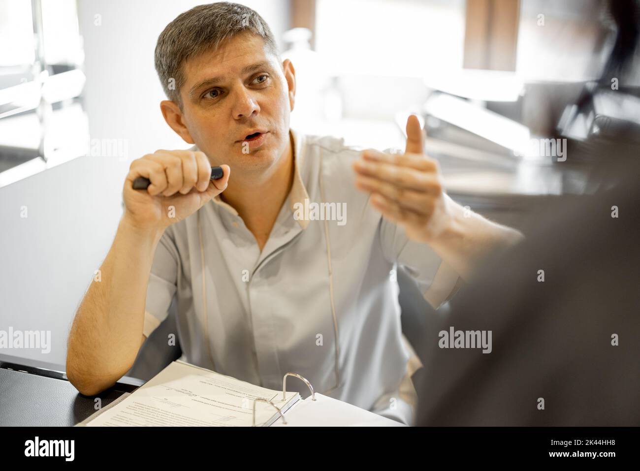 Senior therapist during consultation in office Stock Photo