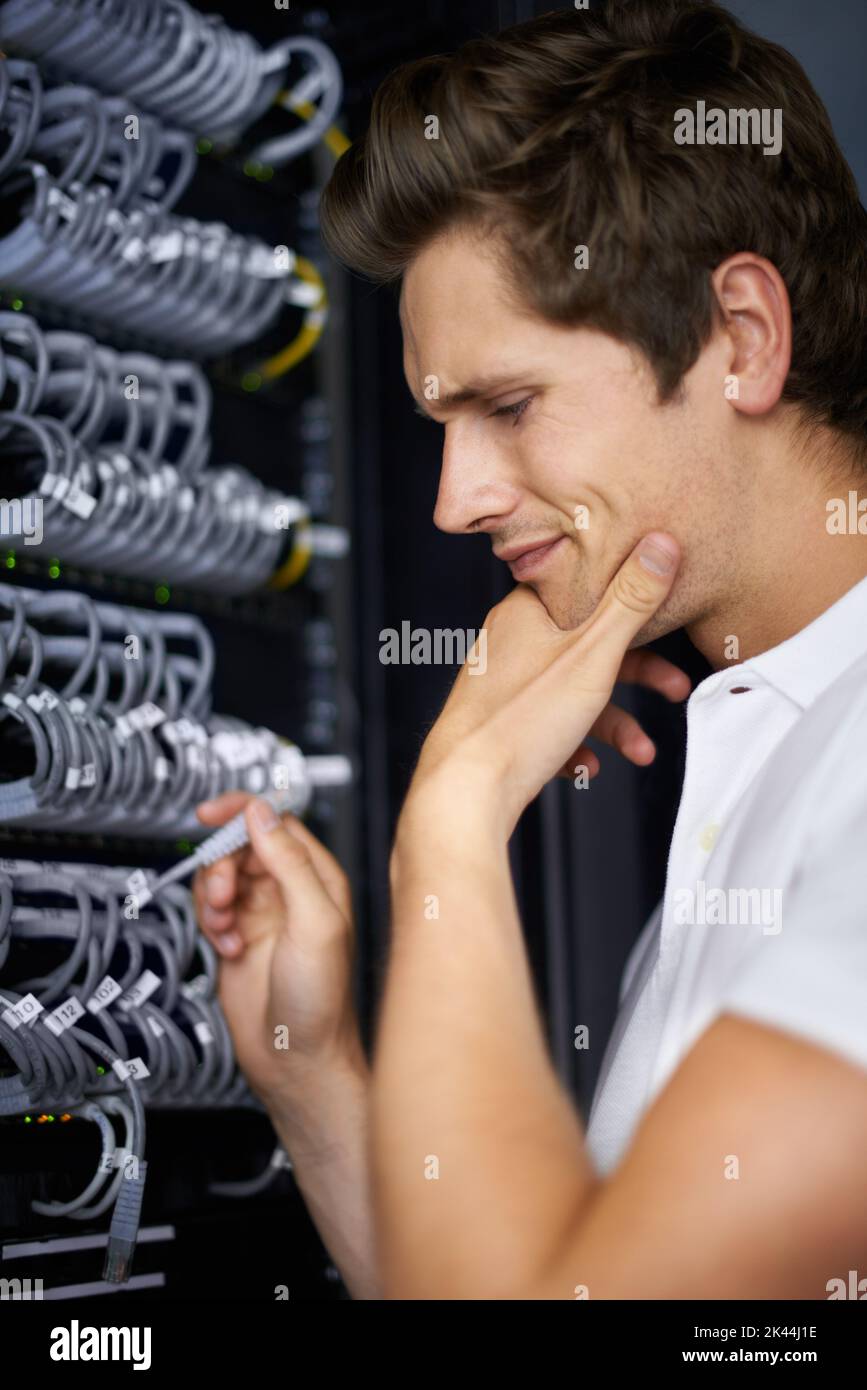 Ready to get you back online. A computer technician connecting cables. Stock Photo