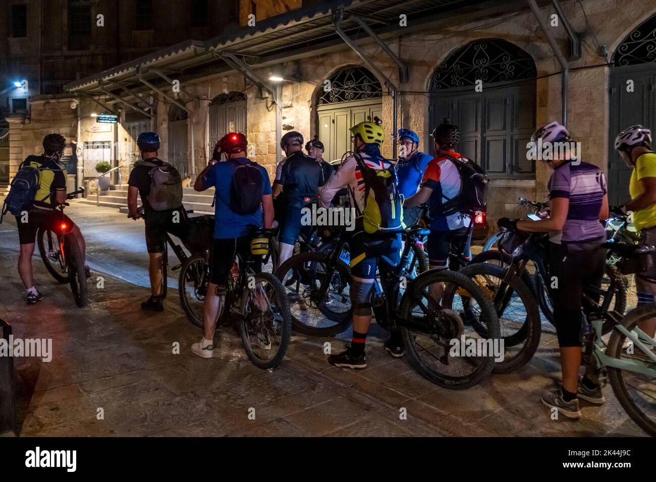A group of bicyclers touring the old city of Jerusalem Israel Stock Photo