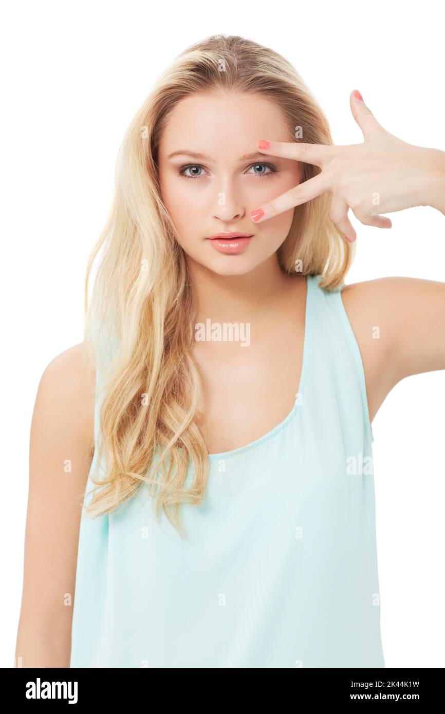 Snip. A pretty young blond woman running her fingers over her eyes while isolated on a white background. Stock Photo
