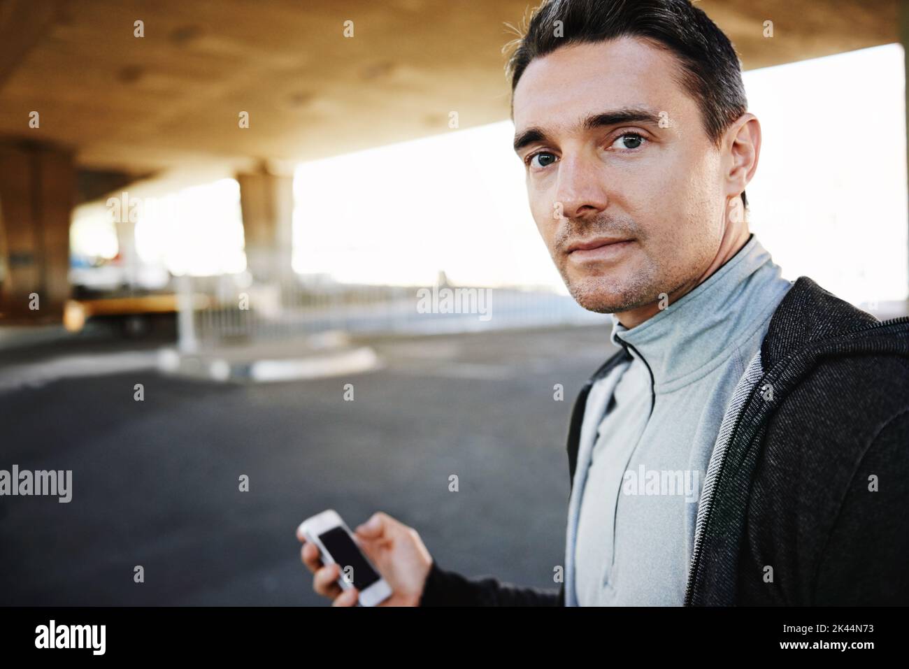 He couldnt imagine life without his phone. a sportsman running through