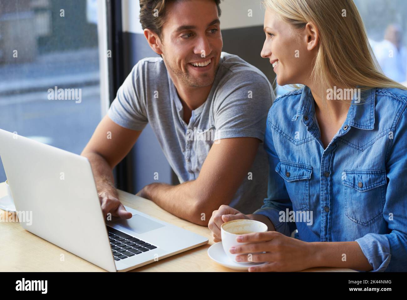 Cafe culture and technology. a young couple using a laptop in a cafe. Stock Photo