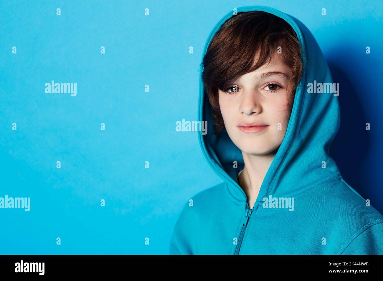 Confident and casual. Portrait of a young boy wearing a blue hoodie in the studio. Stock Photo