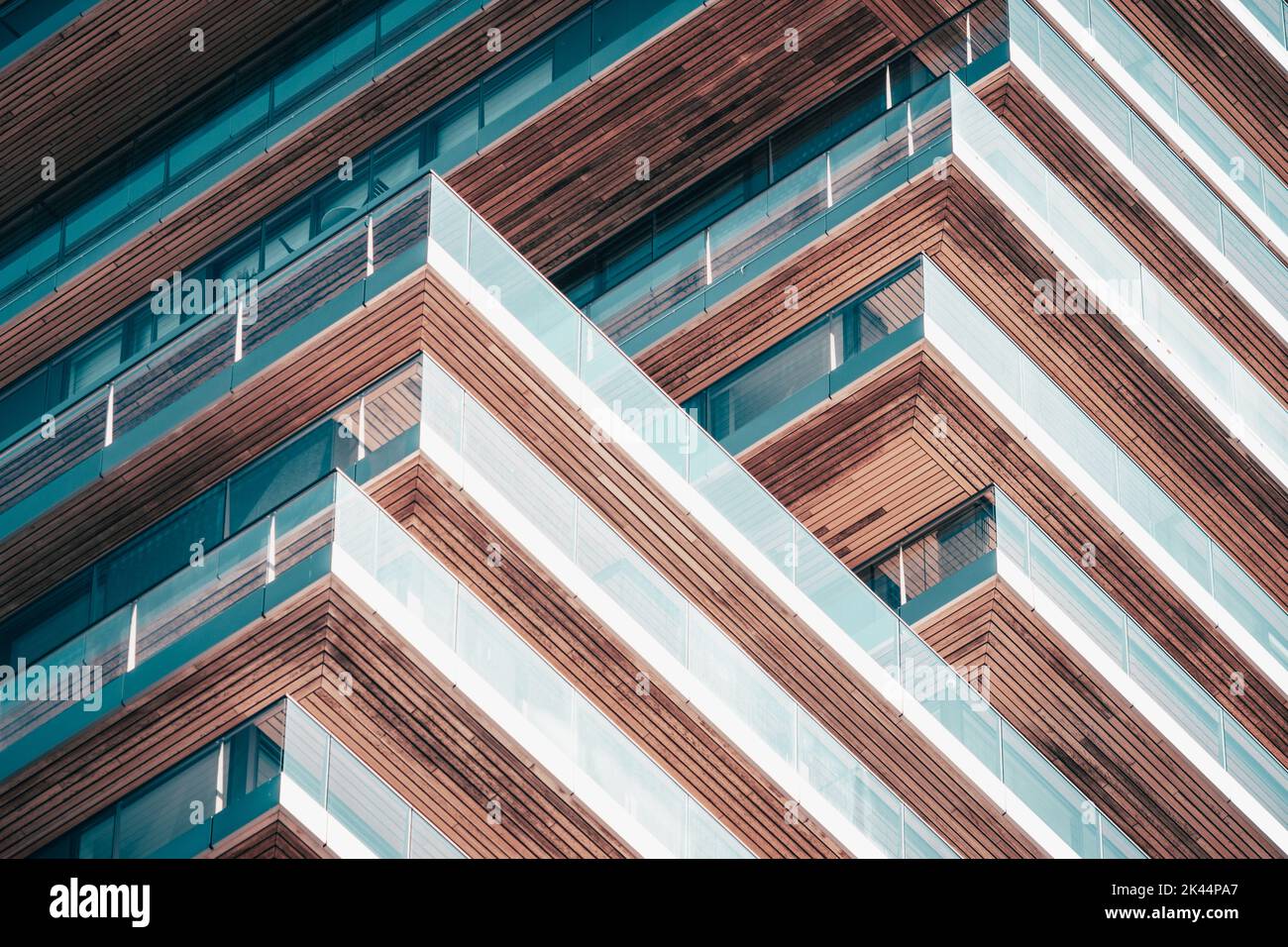 Rotterdam, Netherlands - May 8, 2022: New apartment building in the waterfront of Meuse River. Low angle view of the terraces Stock Photo