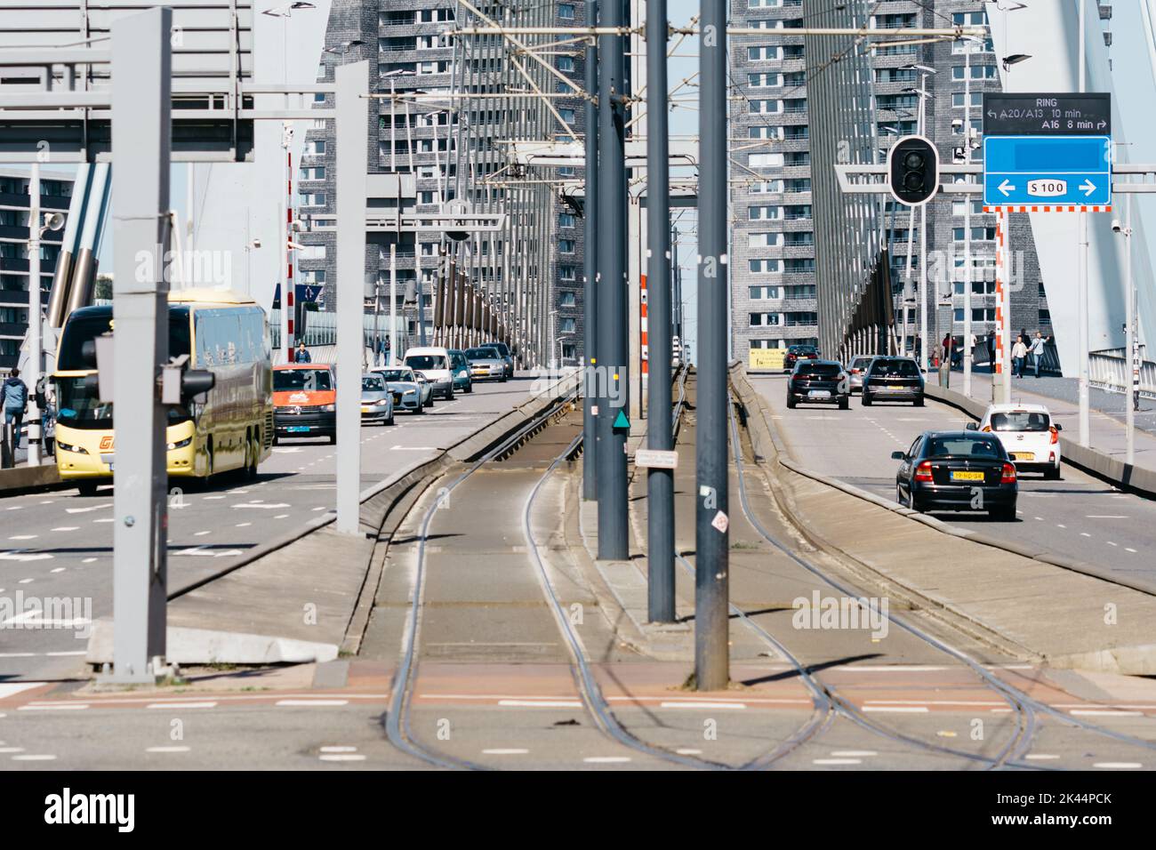 Rotterdam, Netherlands - May 8, 2022: People crossing and vehicles driving on the Erasmusbrug bridge over New Meuse river. Sunny day of spring Stock Photo