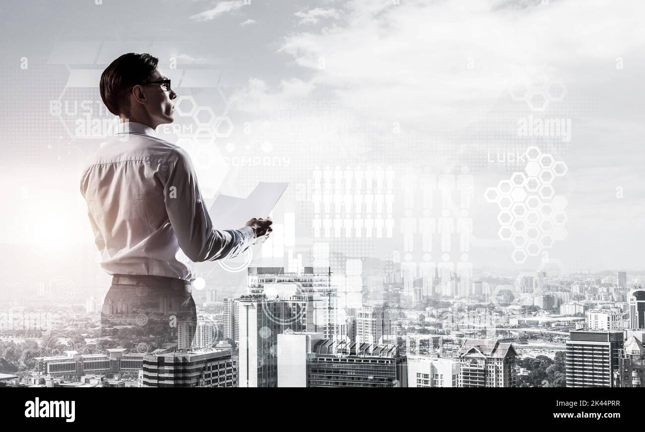 Concept of business success and control with confident boss against cityscape background Stock Photo