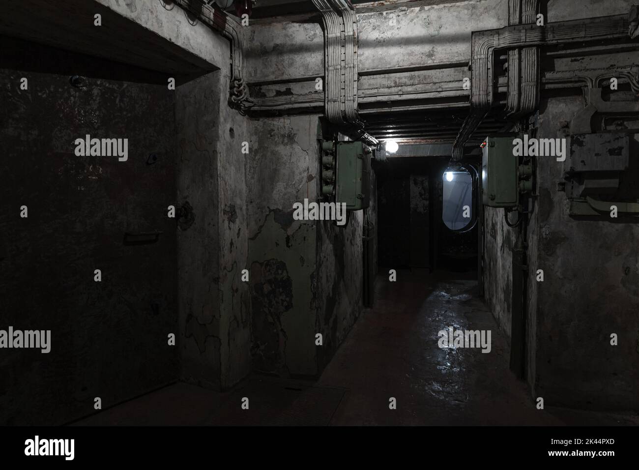Abstract dark military bunker interior, grungy underground rooms with poor illumination Stock Photo