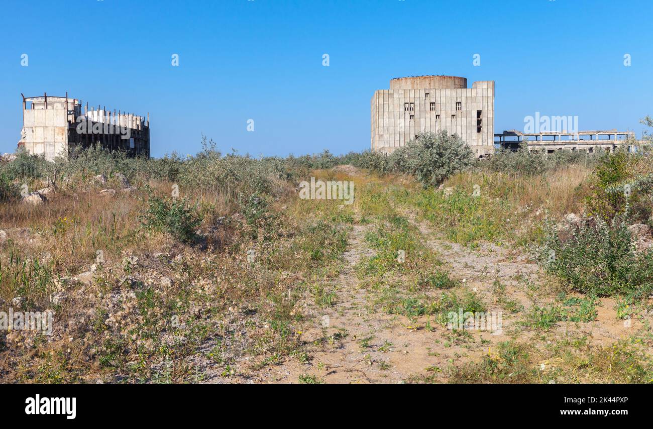 Unfinished concrete buildings of abandoned Crimean Atomic Energy Station on a sunny day. Cape Kazantyp landscape, Crimea Stock Photo