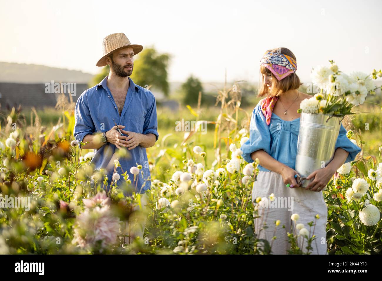 Man and woman pick up flowers at farm outdoors Stock Photo Alamy