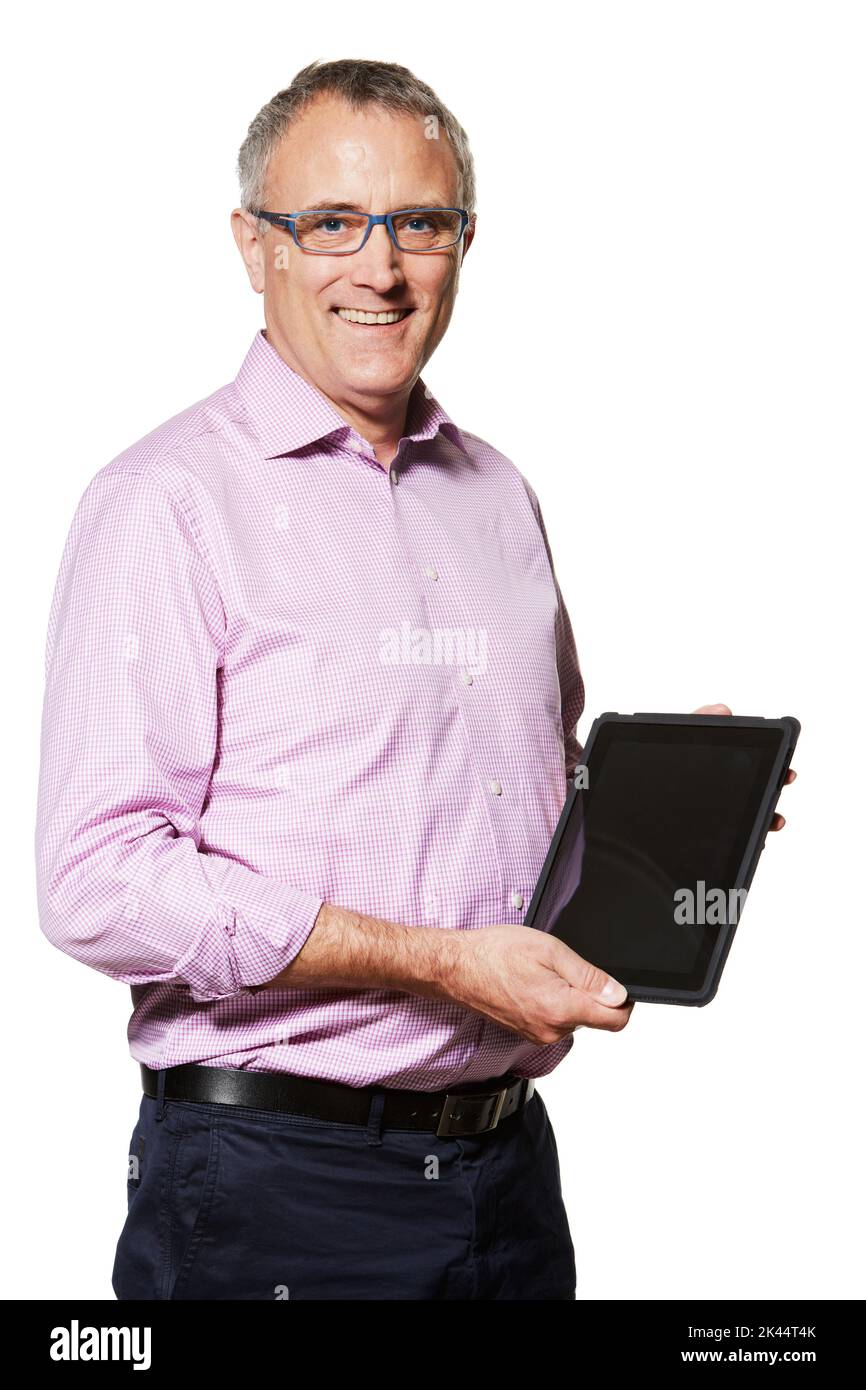 Staying abreast of new technology. Studio portrait of a mature man holding up a digital tablet with a blank screen. Stock Photo