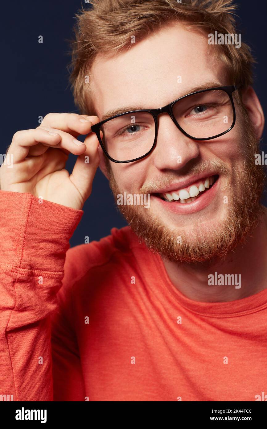 Hey there....Cropped view of a young man smiling while wearing hipster glasses. Stock Photo