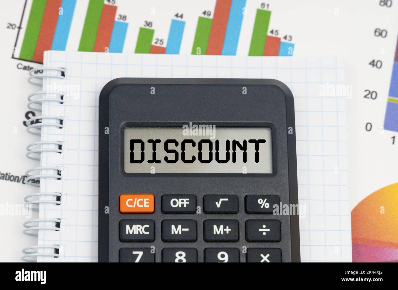 Business and economy concept. On the table are charts, a notebook and a calculator with the inscription - DISCOUNT Stock Photo