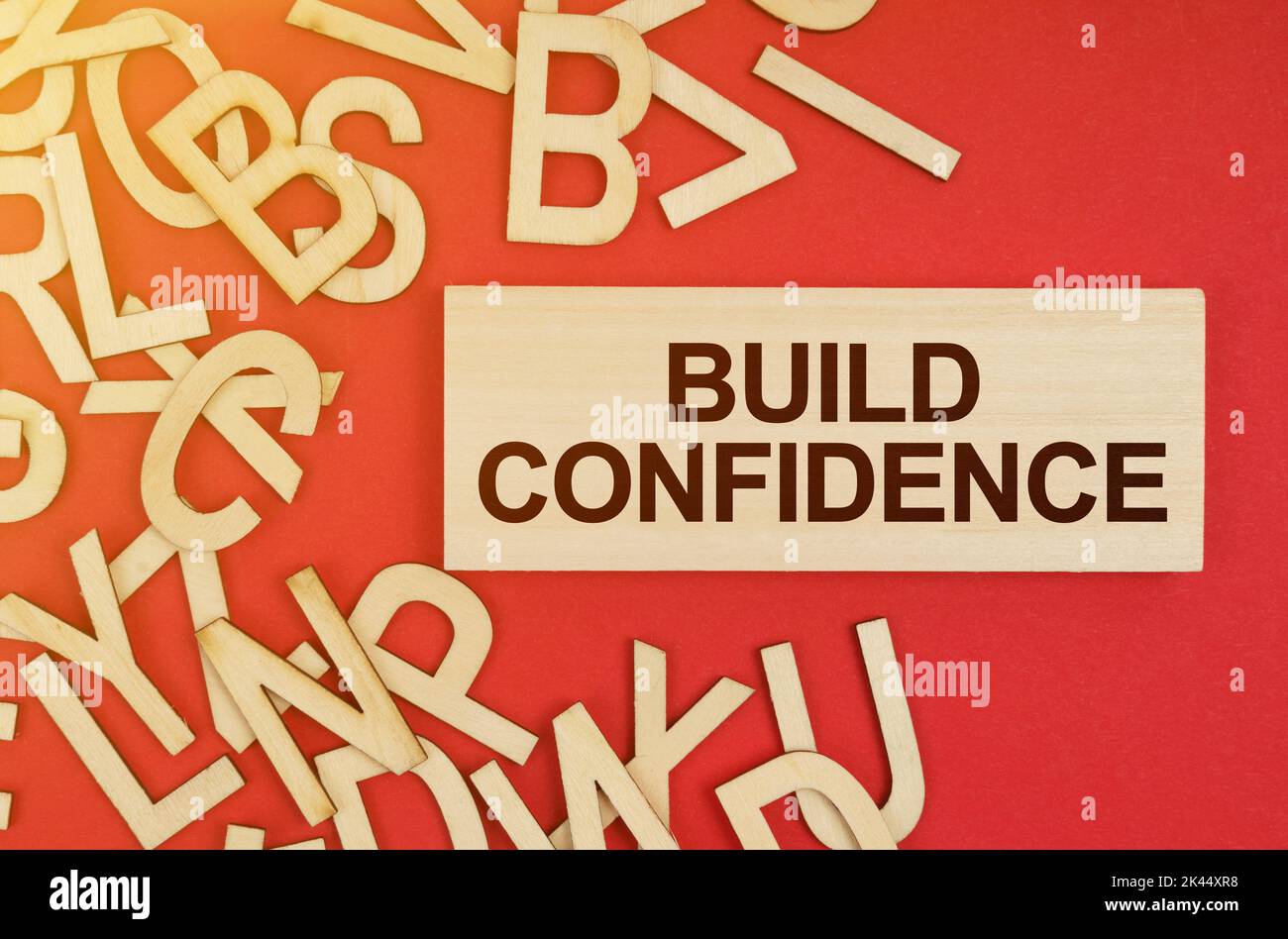 Business and finance concept. On a red background, there are wooden ...