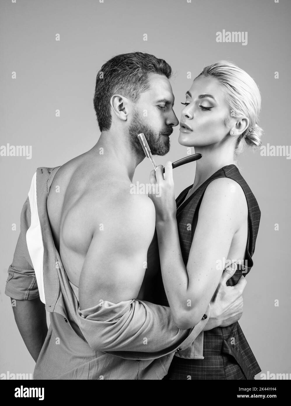 sensual undressed couple. naked woman shaving bearded man. sexy couple in love. Stock Photo