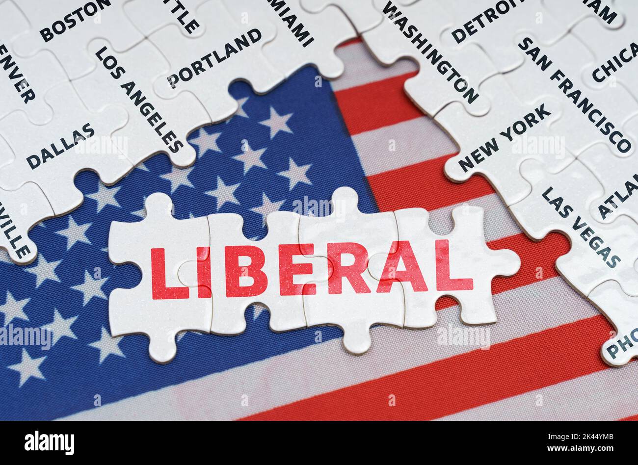 National concept. The USA flag has city name puzzles and puzzles with the inscription - Liberal Stock Photo